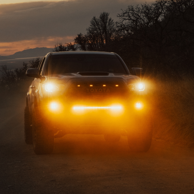 Load image into Gallery viewer, amber behind the grille LED light bar mounted on a toyota tacoma