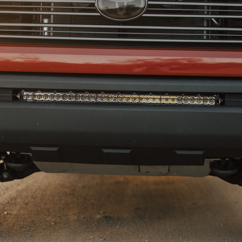 Load image into Gallery viewer, close up of a clear behind the grille light bar mounted on a toyota tundra