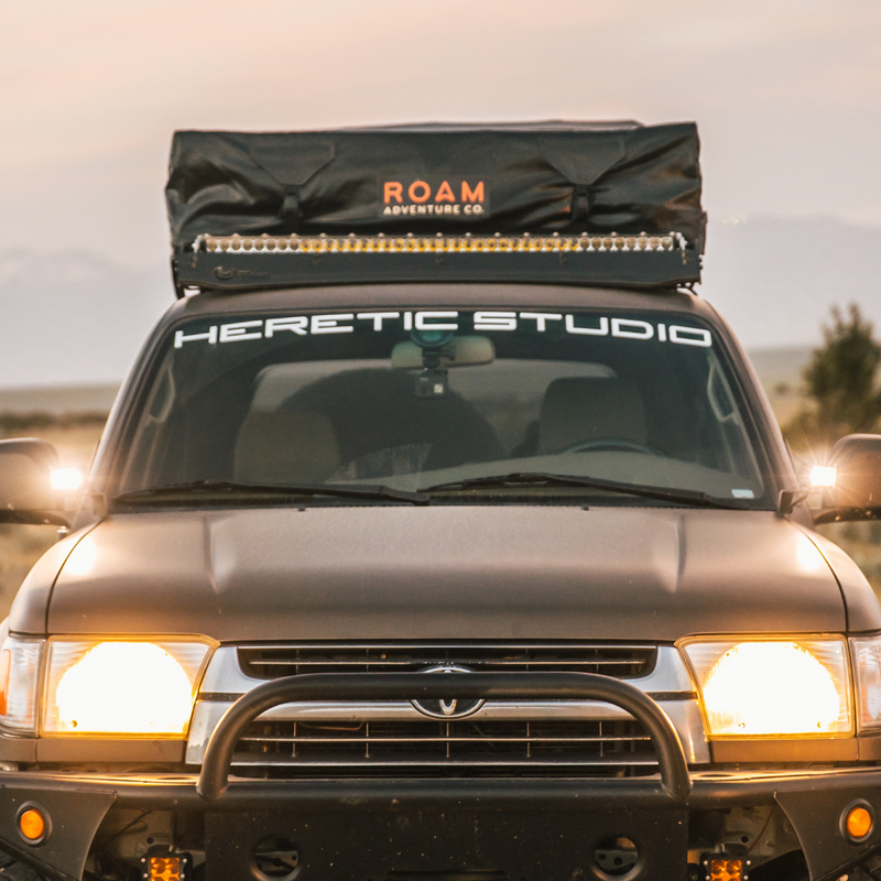 Load image into Gallery viewer, heretic's ba-2 pod light mounted as ditch lights on a toyota