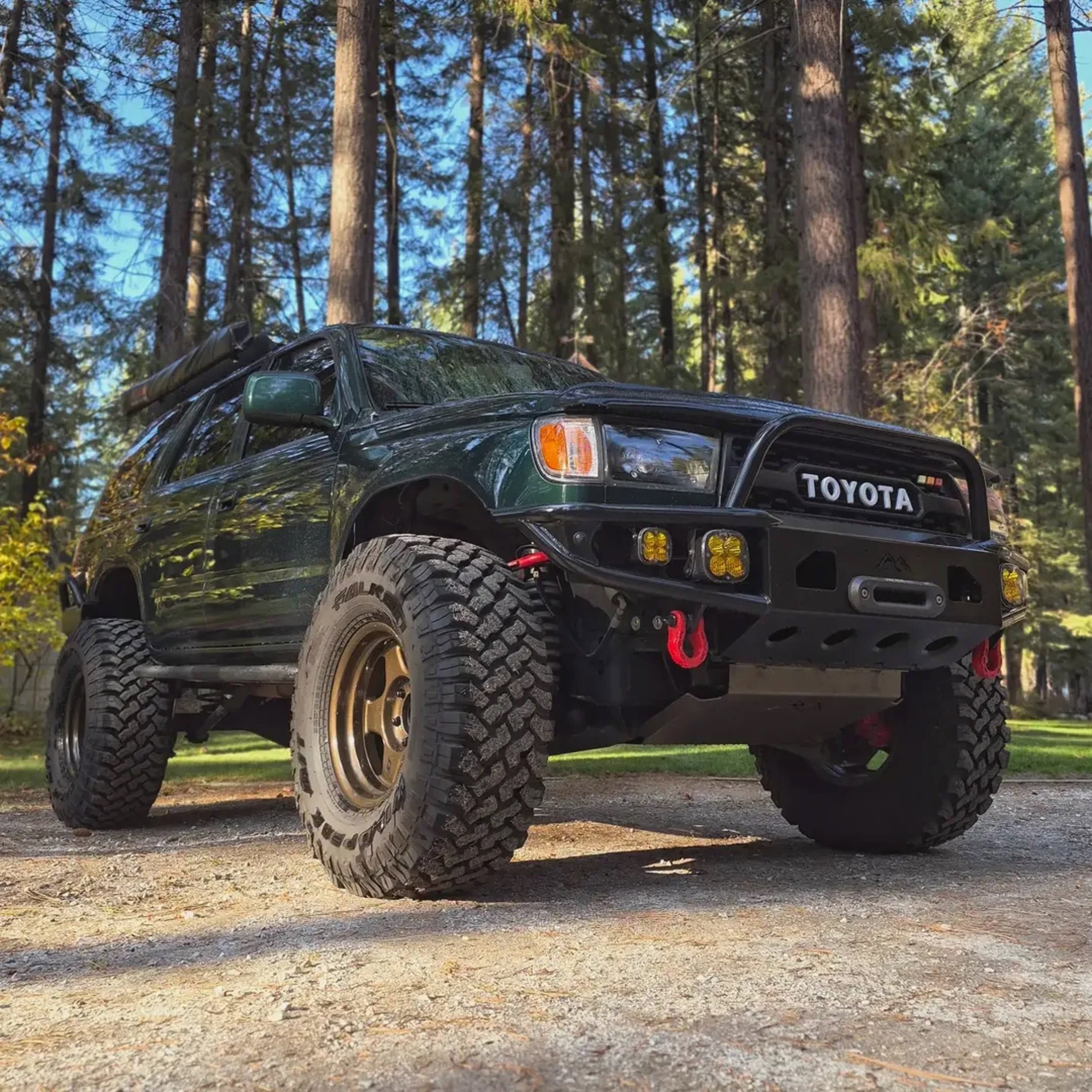Dark green Toyota 4Runner on a wooded trail