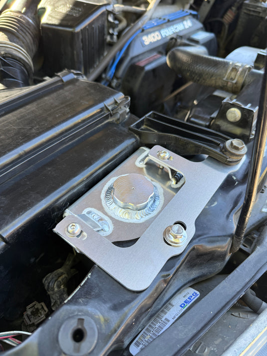 Snowbound Customs aluminum washer fluid reservoir installed behind the passenger headlight