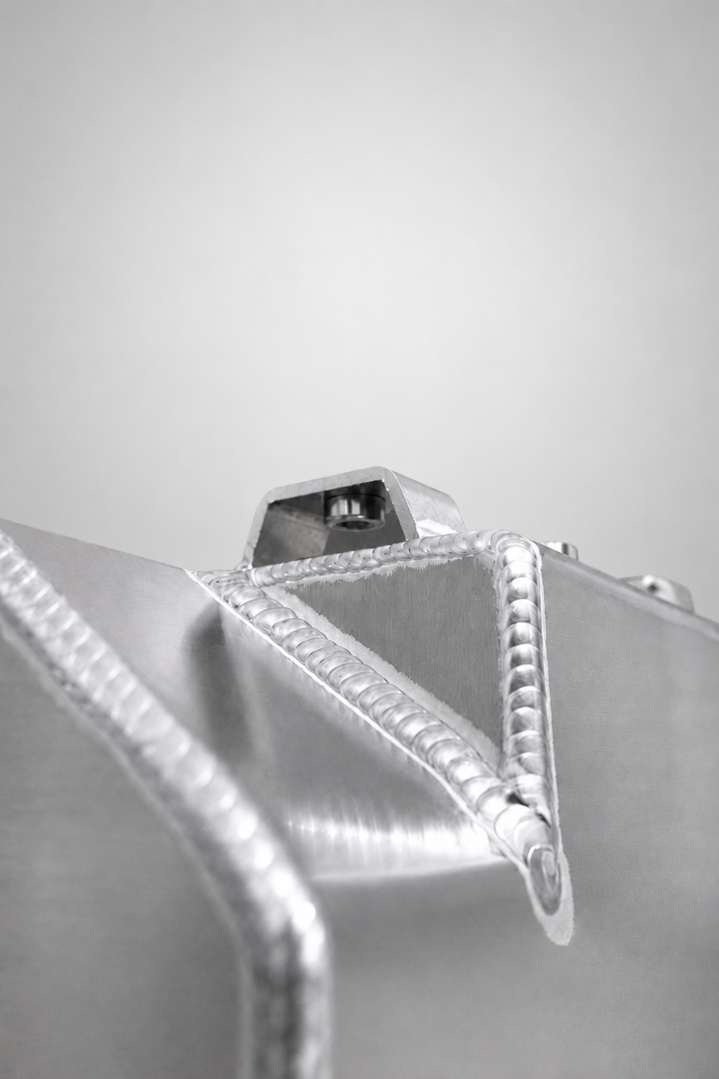 Load image into Gallery viewer, Weld and mounting tab on the Snowbound Customs aluminum washer fluid reservoir
