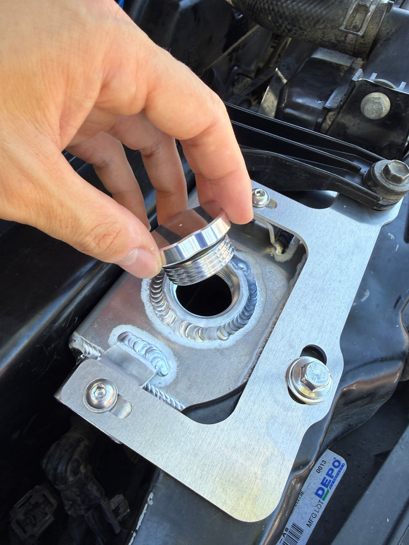 Load image into Gallery viewer, Removal of the billet aluminum cap from the installed Snowbound Customs reservoir
