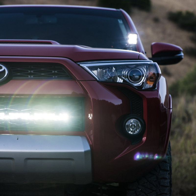 Load image into Gallery viewer, led quattro pod light mounted as a ditch light on a toyota 4runner
